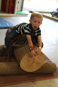 Toddler riding log