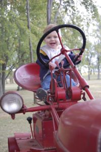 Baby riding tractor